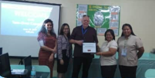 Picture of the Pacific Vision staff, Ms. Joy Kamacho and Mr. Barry Burgees with Mrs. Corazon Salvador and Ms. Larnie Lebuna of PNSB