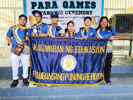 PNSB athletes and coaches holding the NCR banner with text "Kagawaran ng Edukasyon Pambansang Punong Rehiyon" and the NCR logo at the center